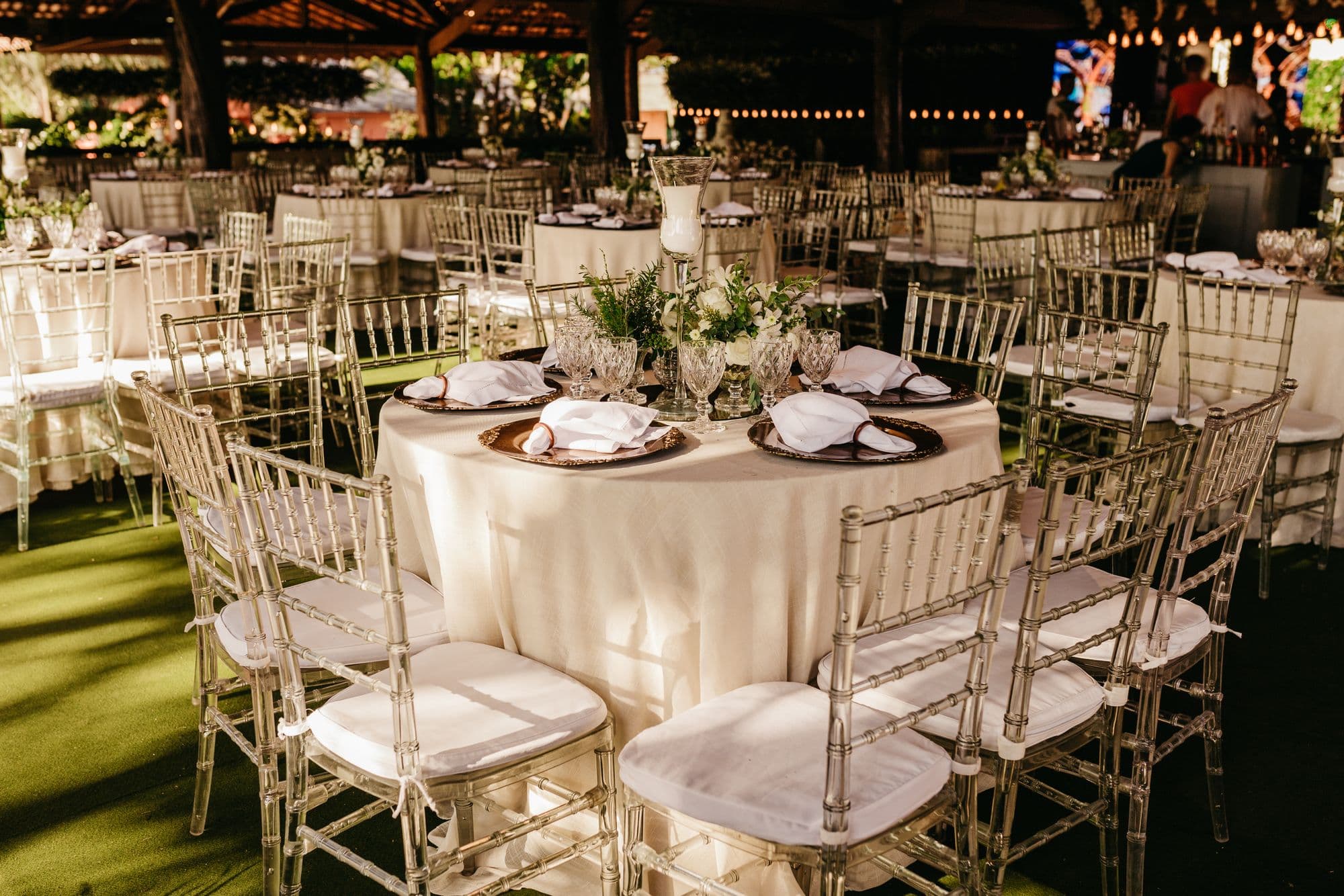 A reception set with round tables under warm evening light